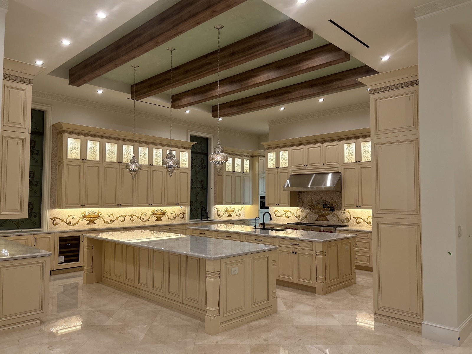 Custom kitchen with under-cabinet, pendant and recessed lighting